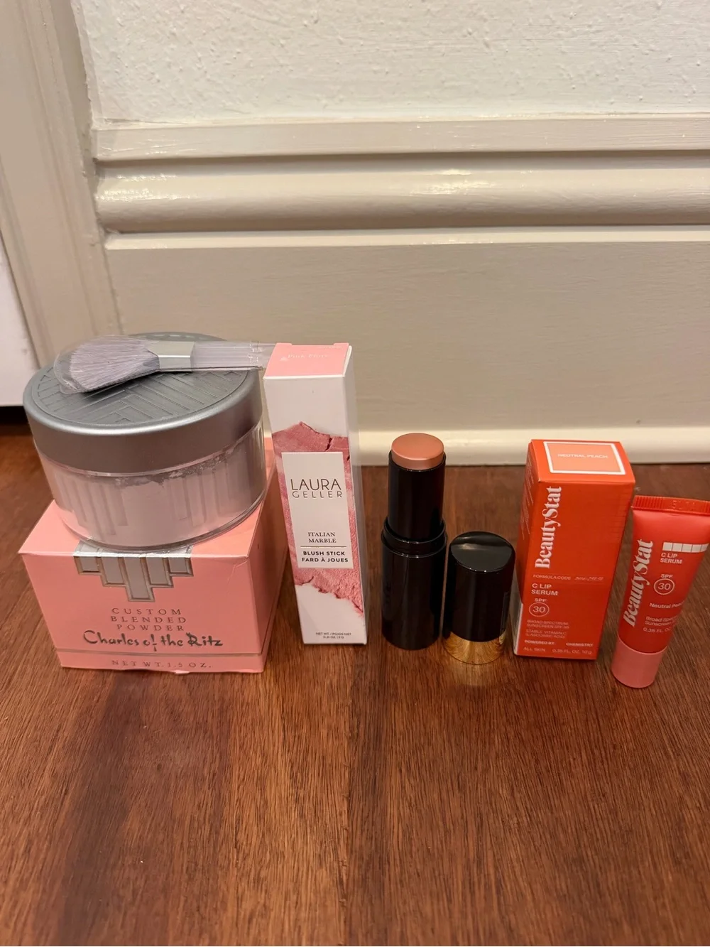 Laura Geller Pink Blush Stick & Lip Serum and charles of the ritz powder